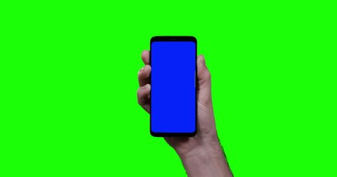 man's hand holding smartphone with blue croma key and green screen in background swipe one time to the left side shot in 4k one click keyable