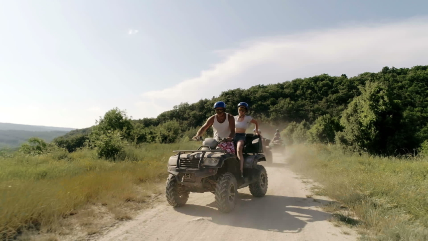 Cheerful company on vacation ..video of young people riding ATVs . Four-wheel ATV transport and extreme sport.little fun.ATVs.Quad Bikes.