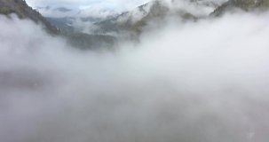 Beautiful flying above the clouds in the mountains. Aerial drone flight in the clouds at high altitude