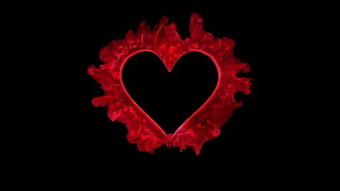 Red color heart shaped Valentine's Day particle love burst. Vivid colored smoke shockwave. Romantic lovely logo and copy space animation. Isolated on black alpha copyspace 4k 60fps