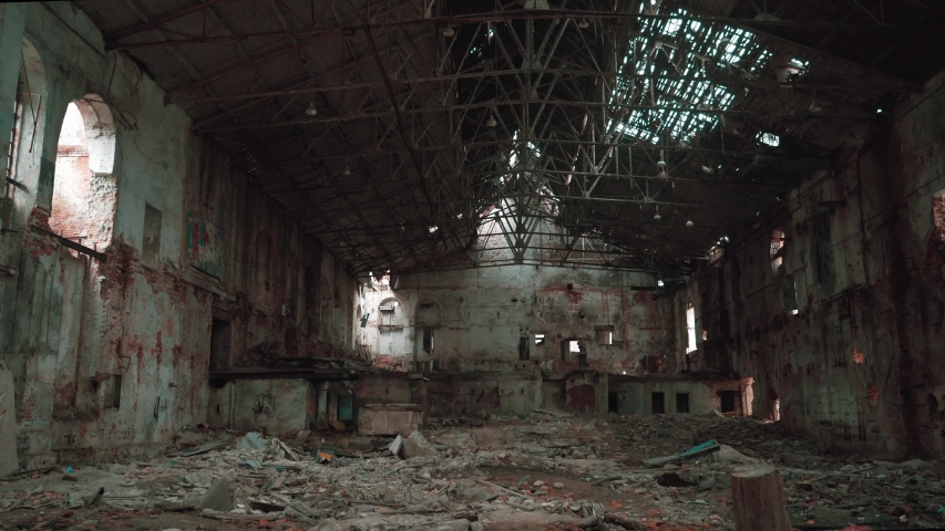 Moving inside ruined and abandoned large creepy industrial factory warehouse hangar