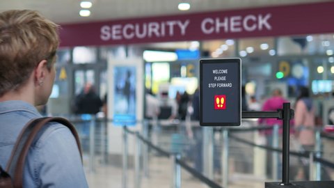 facial recognition system new technology woman goes through airport security control