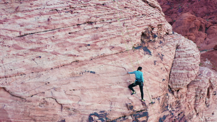 Aerial shot of female rock climber figuring out crux move at Red Rock Canyon