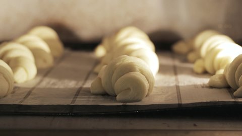 baker making croissants, forming and kneading dough, time lapse from croissants in oven