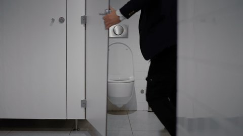 Businessman wanting to toilet room.