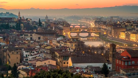 Sunset view of Florence, Italy. Time lapse of evening Florence old town with city lights. Zoom out shot, 4K UHD
