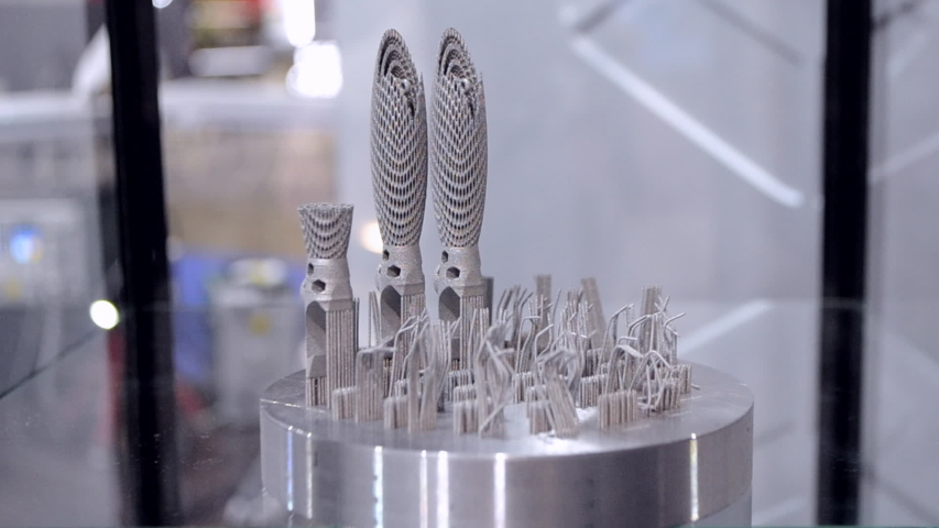 Object printed on metal 3d printer close-up. Object printed in laser sintering machine. Modern 3D printer printing from metal powder. Concept progressive additive DMLS, SLM, SLS 3d printing technology