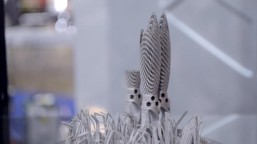 Object printed on metal 3d printer close-up. Object printed in laser sintering machine. Modern 3D printer printing from metal powder. Concept progressive additive DMLS, SLM, SLS 3d printing technology