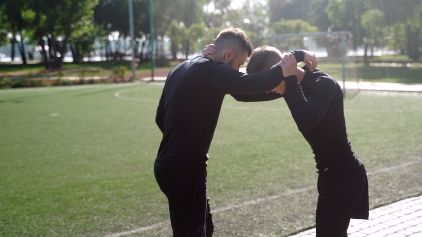 Two fighters practice mma skills in training
