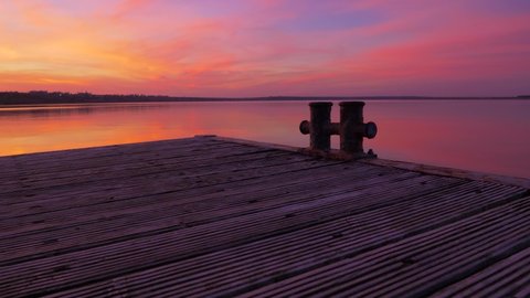panorama over a wooden pier on a charming landscape iridescent gradient of sunset colors at sea