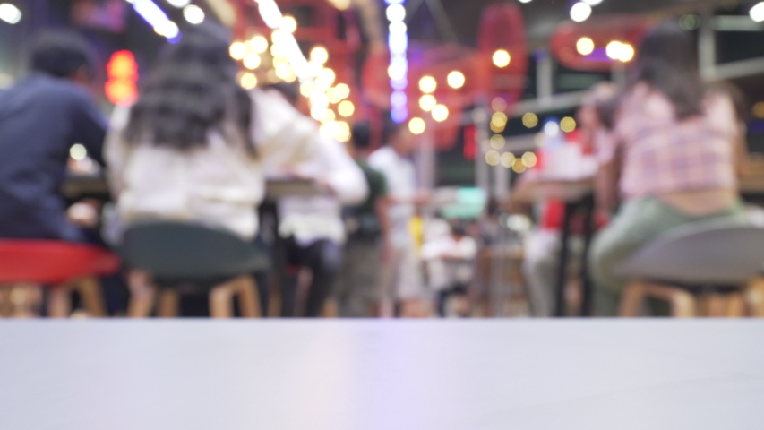 Defocused People in fast food cafe in food court of shopping mall 