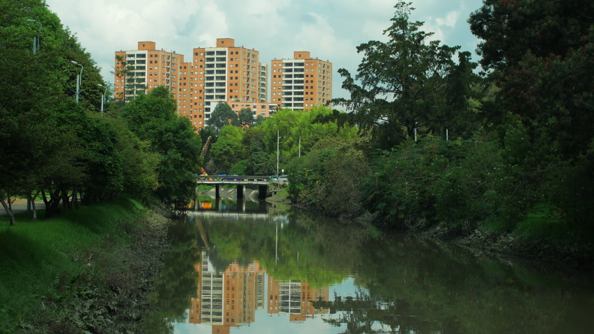 View of green lush peaceful "humedal" waterway and residential area in Northern Bogotá, Colombia, wide shot