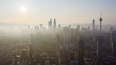 Time lapse: Aerial Kuala Lumpur city centre view during dawn overlooking the city skyline. Hyperlapse. Zoom in motion timelapse. Prores Full HD.