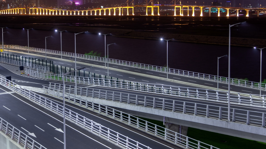 Macau bridge traffic cityscape night timelapse pan up