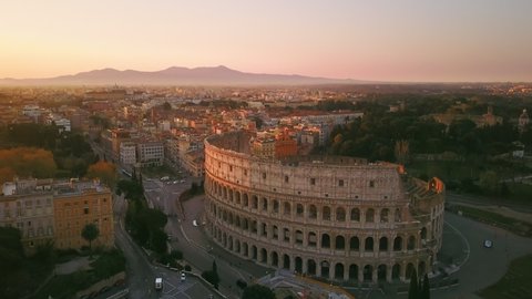 rome colosseum aerial view drone at sunrise fly orbit over city centre