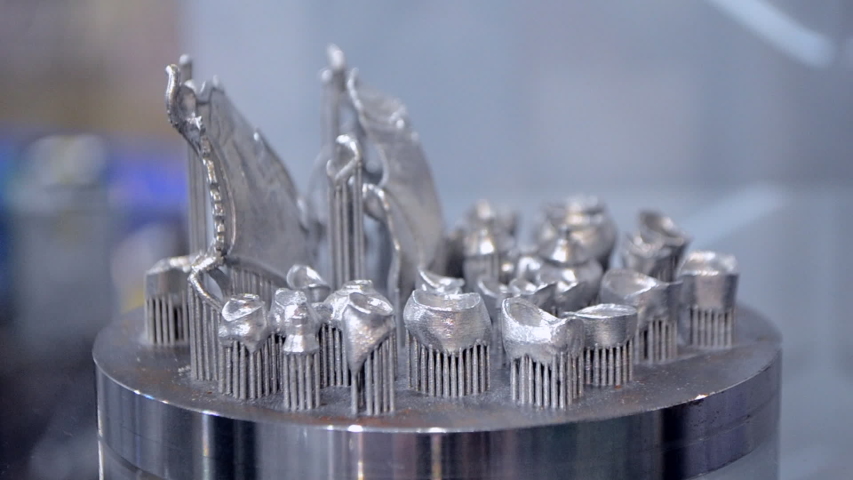 Object printed on metal 3d printer close-up. Object printed in laser sintering machine. Modern 3D printer printing from metal powder. Concept progressive additive DMLS, SLM, SLS 3d printing technology