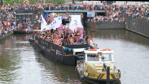 Amsterdam, The Netherlands. 3rd August 2019. Group of gay men and women marching in the boat parade of the Channel Gay Pride
