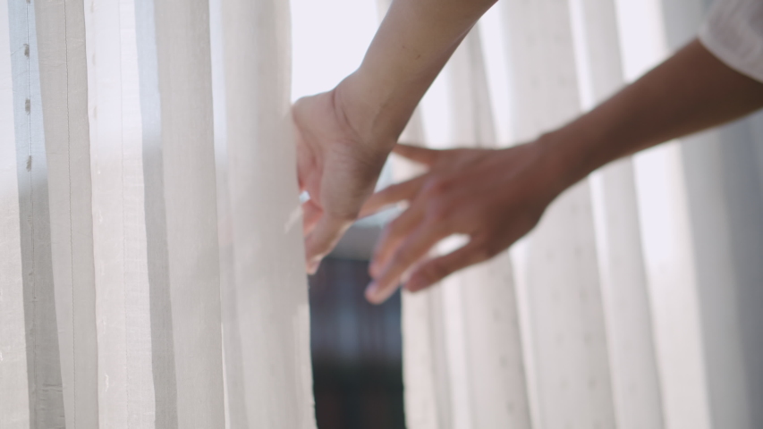 Close up Hand of young women opening  window curtain in the morning at home her | Shutterstock HD Video #1043135473