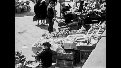 Naples, Italy, 1955 - Among the crowd of the Porta Capuana market a beautiful girl stands with decisive step a beautiful girl