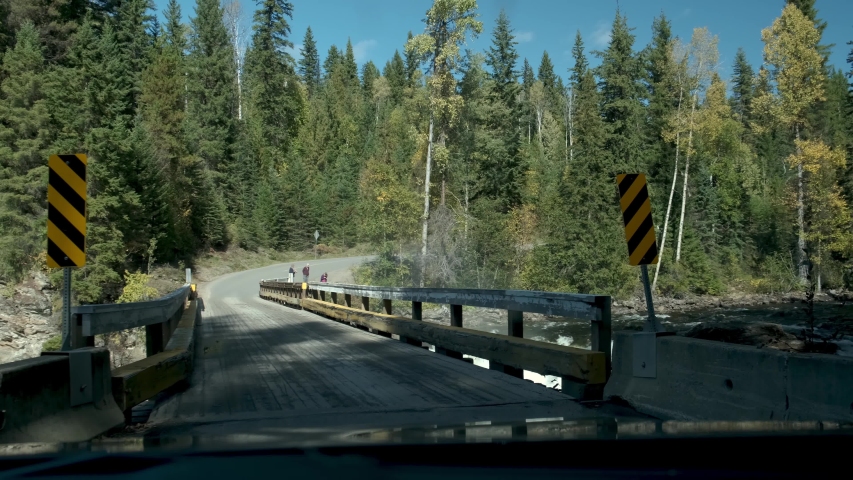 Winter mountain road with Rocky Mountains in a background, Alberta, Canada October 2019