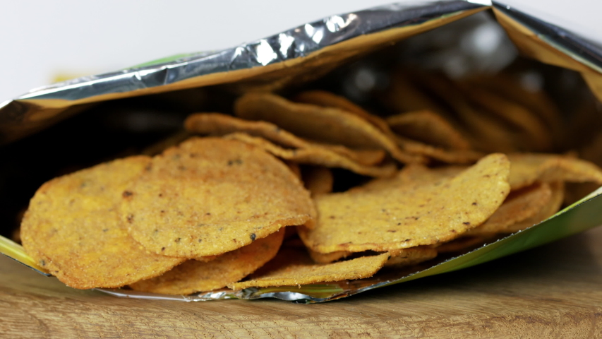 Two hands taking nachos from the package HD | Shutterstock HD Video #1043166805