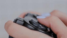 Close up side view of woman gamer hand playing video games with black joystick or gamepad at home. Gaming, hobby, addiction, video game and leisure time concept