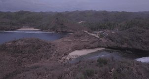Aerial view, bird view, from the hills and the beautiful white sand beach when the sunset comes, raw footage, ungraded, no color