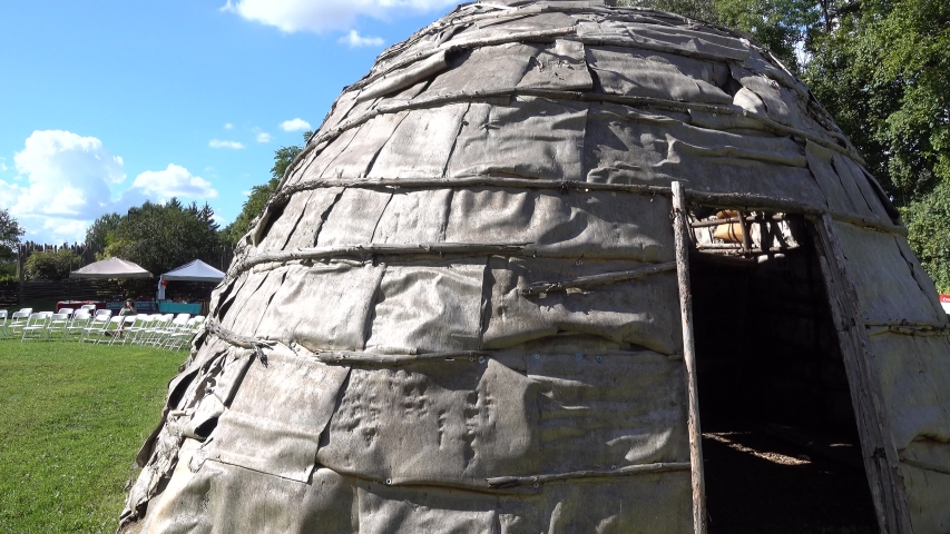 Left To Right Panorama Of Native American Indian First Nations Teepee Loghome Then Girl Running By