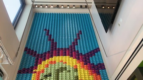 New York, NY / USA - May 25, 2019: A wall of Crocs shoes shaped in the image of the Statue of Liberty on display in a Crocs store in New York.