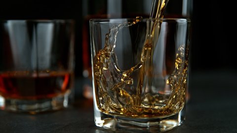 Super Slow Motion Shot of Pouring Whiskey into Glass at 1000fps with Camera Movement.
