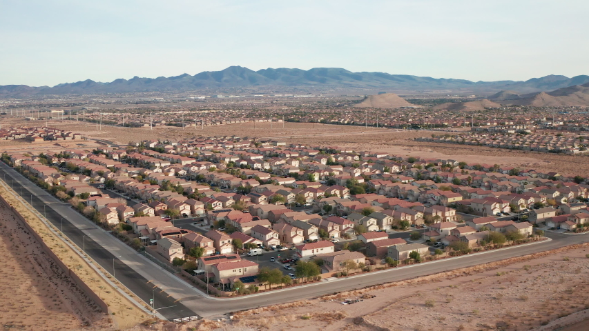 Aerial view of Las Vegas suburban homes with desert mountains, hills landscape