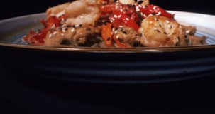Tasty Mix of Seafood on the Plate is Rotating Against the Black Background, Slow Motion, RED Camera, 4k, Macro Food Video