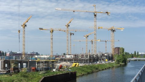 BERLIN, GERMANY, MAY 3, 2018: Many operating cranes at construction site in Berlin Mitte.