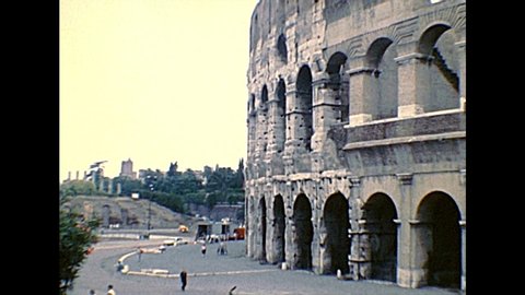 ROME, ITALY - circa 1986: Side view of the Colosseo, Colosseum, Flavian Amphitheatre, world largest amphitheater, and symbol of Rome city. Historical archival of Rome capital of Italy in the 1980s.