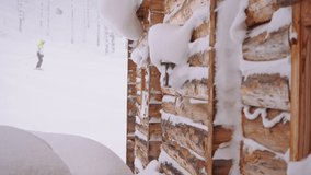 Heavy snowfall in a wintry mountain alpine village, skier passes a wooden house - Powered by Shutterstock - Get 15% off with code: PIKWIZARD15