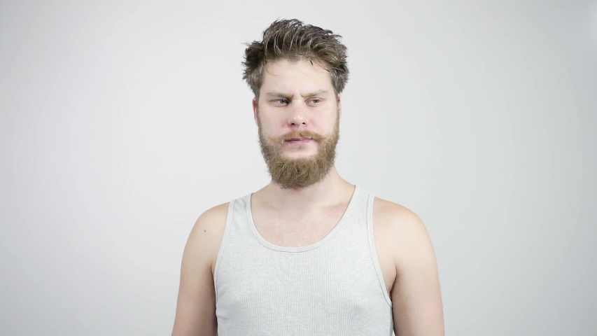 Young bearded man sniffing his armpit, something stinks very bad. Royalty-Free Stock Footage #1043218951