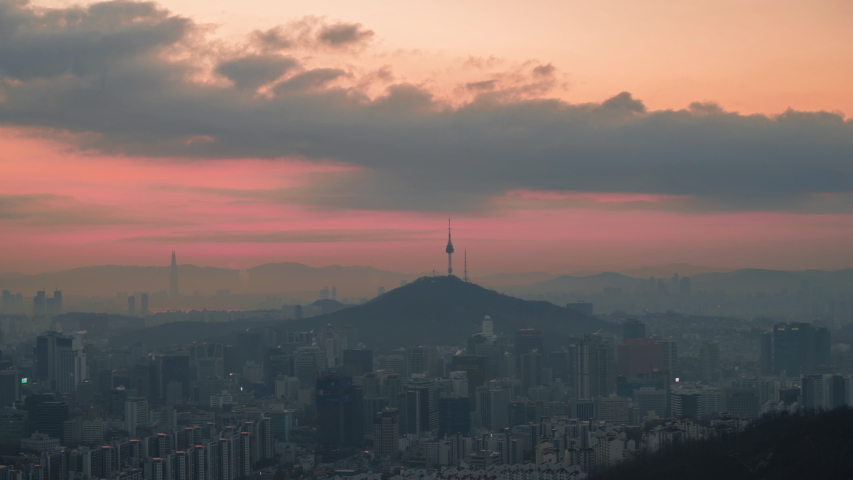 Time lapse4k. view of seoul City sky line , south korea, showing landmark Seoul tower in the financial district during sunrise