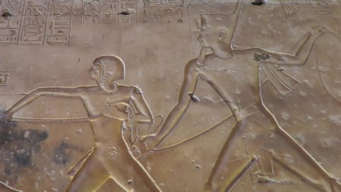CGI of ancient Egyptian carvings of Prince Amun-her-khepeshef at the Temple of Abydos Egypt, pan to left shot, shallow depth of field.