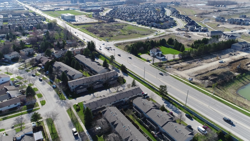 Two Lanes Of Traffic In Front Of New Housing Construction Development 002