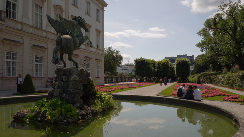 sunny day salzburg city famous tourist crowded garden fountain slow motion panorama 4k austria