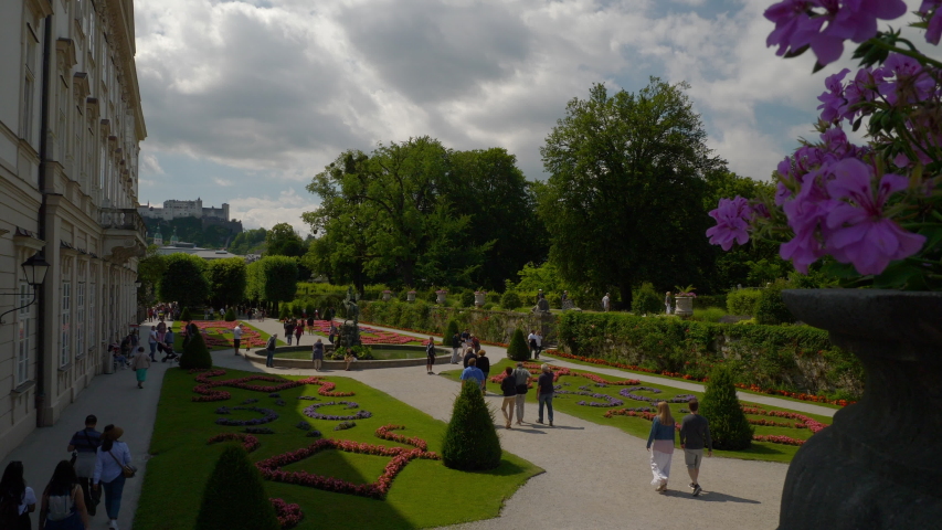 sunny summer day salzburg city famous tourist crowded garden slow motion panorama 4k austria