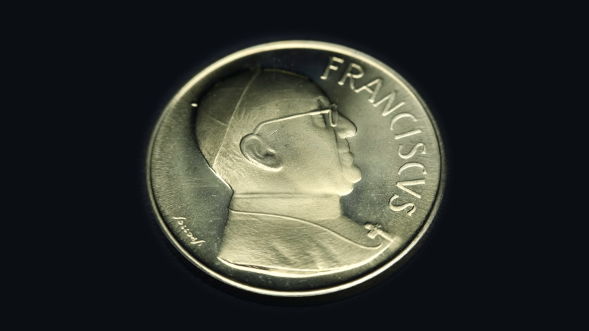 Commemorative medal token, ROMA, FRANCISCVS rotates on a black background. Macro. Closeup