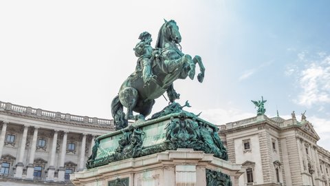 Equestrian statue of Prince Eugene of Savoy timelapse hyperlapse (Prinz Eugen von Savoyen) in front of Hofburg palace, Heldenplatz, Vienna, Austria. Blue cloudy sky