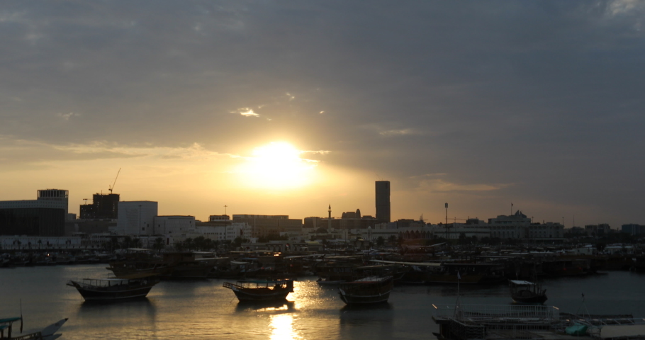 Sunset in Doha bay with traditional dhows boats.Qatar