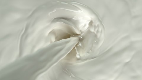 Super Slow Motion Shot of Pouring Milk into Fresh Cream Vortex at 1000 fps.