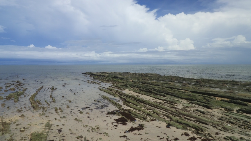 Thick, low cloud formation moving above the low tide of Bak Bak Beach in Kudat, Sabah. 