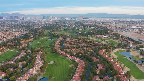 Aerial pullback shot of Las Vegas residential community, houses, golf course