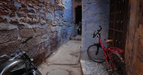 Narrow street, bycicle and painted houses of famous Jodhpur the Blue City. Jodhpur, Rajasthan, India.