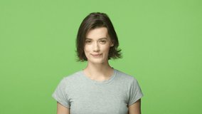Happiness, health care, lifestyle concept. Slow-motion gorgeous young short-haired woman with braces, smiling lovely, take care teeth, look forward perfect smile, standing green background