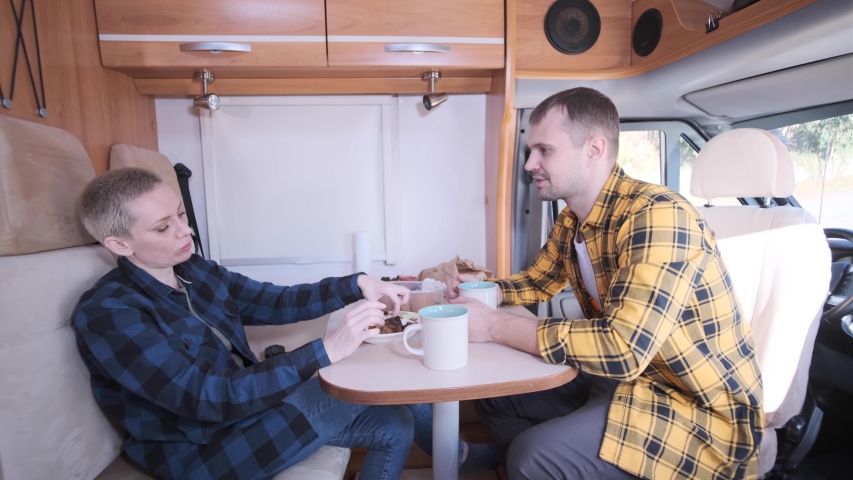 Family trip. Life in the motorhome. A way of life. RV. Camping. Discussion of problems sitting at the table. A joint dinner. Food. Dinner at the table. A nature trip. Trailer.